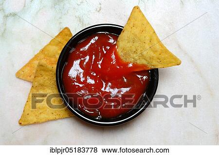 Stock Photo - Nachos with tomato dip, snack, starter, chip, chips, salsa, dip sauce, dip sauce, corn chips. Fotosearch
