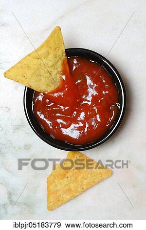 Stock Photo - Nachos with tomato dip, snack, starter, chip, chips, salsa, dip sauce, dip sauce, corn chips. Fotosearch
