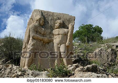 Stock Image - Nemrud National Park, Adiyaman Province, Anatolia, Kahta, Kommagene, Nemrut, Statue, Relief Antiochus I. with Heracles-Anlagnes, Dexiosos scene, Turkey, Asia. Fotosearch