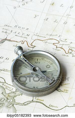 Stock Image - Old compass on map, orientation, discovery, explorer. Fotosearch