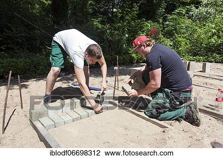 Paving work, carried out by trainees as garden and landscape builders View Large Photo Image Stock Image - Paving work, carried out by trainees as garden and landscape builders. Fotosearch