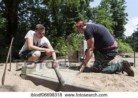 Paving work, carried out by trainees as garden and landscape builders View Large Photo Image Stock Photo - Paving work, carried out by trainees as garden and landscape builders. Fotosearch