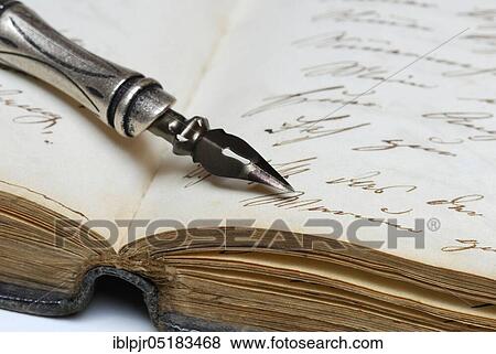 Stock Photo - Pen with nib on book, old writing, ink, diary. Fotosearch
