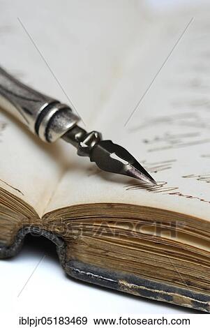 Stock Photo - Pen with nib on book, old writing, ink, diary. Fotosearch