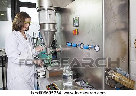 PhD student during her research work on a Hüttlin-Mycrolab machine (fluid bed granulator) at the Institute of Pharmaceutical Technology and Biopharmacy at Heinrich-Heine-University Düsseldorf, North Rhine-Westphalia, Germany, Europe View Large Photo Image Picture - PhD student during her research work on a Hüttlin-Mycrolab machine (fluid bed granulator) at the Institute of Pharmaceutical Technology and Biopharmacy at Heinrich-Heine-University Düsseldorf, North Rhine-Westphalia, Germany, Europe. Fotosearch