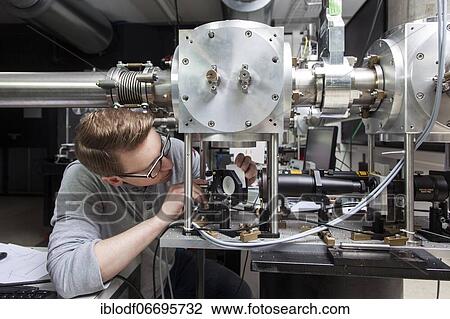 PhD student during his research work adjusting his experimental setup, laser laboratory of Prof. Georg Pretzler's group for laser and plasma physics at Heinrich-Heine-University, Düsseldorf, North Rhine-Westphalia, Germany, Europe View Large Photo Image Stock Image - PhD student during his research work adjusting his experimental setup, laser laboratory of Prof. Georg Pretzler's group for laser and plasma physics at Heinrich-Heine-University, Düsseldorf, North Rhine-Westphalia, Germany, Europe. Fotosearch