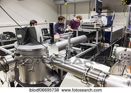 PhD student during his research work adjusting his experimental setup, laser laboratory of Prof. Georg Pretzler's working group for laser and plasma physics at Heinrich Heine University, Düsseldorf, North Rhine-Westphalia, Germany, Europe View Large Photo Image Stock Photo - PhD student during his research work adjusting his experimental setup, laser laboratory of Prof. Georg Pretzler's working group for laser and plasma physics at Heinrich Heine University, Düsseldorf, North Rhine-Westphalia, Germany, Europe. Fotosearch