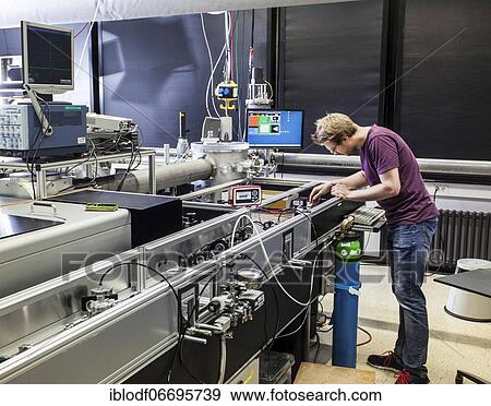 Stock Photo - PhD student during his research work adjusting his experimental setup, laser laboratory of Prof. Georg Pretzler's group for laser and plasma physics at Heinrich-Heine-University, Düsseldorf, North Rhine-Westphalia, Germany, Europe. Fotosearch