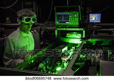 PhD student during his research work adjusting his experimental setup, laser laboratory of Prof. Georg Pretzler's group for laser and plasma physics at Heinrich-Heine-University, Düsseldorf, North Rhine-Westphalia, Germany, Europe View Large Photo Image Stock Photo - PhD student during his research work adjusting his experimental setup, laser laboratory of Prof. Georg Pretzler's group for laser and plasma physics at Heinrich-Heine-University, Düsseldorf, North Rhine-Westphalia, Germany, Europe. Fotosearch