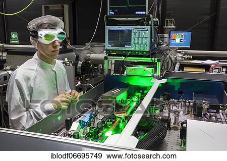 PhD student during his research work adjusting his experimental setup, laser laboratory of Prof. Georg Pretzler's group for laser and plasma physics at Heinrich-Heine-University, Düsseldorf, North Rhine-Westphalia, Germany, Europe View Large Photo Image Stock Photo - PhD student during his research work adjusting his experimental setup, laser laboratory of Prof. Georg Pretzler's group for laser and plasma physics at Heinrich-Heine-University, Düsseldorf, North Rhine-Westphalia, Germany, Europe. Fotosearch