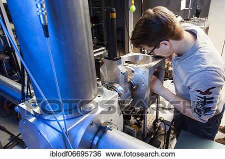 PhD student during his research work adjusting his experimental setup, laser laboratory of Prof. Georg Pretzler's group for laser and plasma physics at Heinrich-Heine-University, Düsseldorf, North Rhine-Westphalia, Germany, Europe View Large Photo Image Stock Photograph - PhD student during his research work adjusting his experimental setup, laser laboratory of Prof. Georg Pretzler's group for laser and plasma physics at Heinrich-Heine-University, Düsseldorf, North Rhine-Westphalia, Germany, Europe. Fotosearch