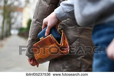 Stock Photograph - Pickpocket, senior citizen, mugging. Fotosearch