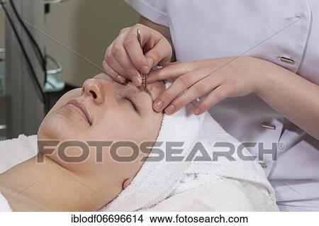 Picture - Plucking eyelashes in practical lessons. Training as a beautician at the vocational school, Düsseldorf, North Rhine-Westphalia, Germany, Europe. Fotosearch