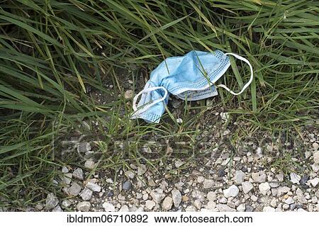 Pollution from discarded mouth-nose covering, face mask in grass by roadside, Corona crisis, Germany, Europe View Large Photo Image Stock Image - Pollution from discarded mouth-nose covering, face mask in grass by roadside, Corona crisis, Germany, Europe. Fotosearch