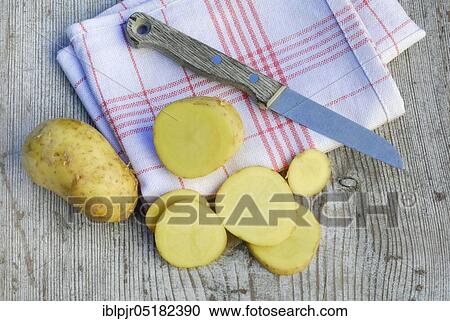Potato slices and potatoes, Charlotte variety, knife View Large Photo Image Stock Image - Potato slices and potatoes, Charlotte variety, knife. Fotosearch