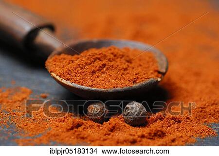 Picture - Powder in a wooden spoon (Berbere), spice mixture of chili, pimento, cardamom, pepper, allspice seeds and spice mixture. Fotosearch