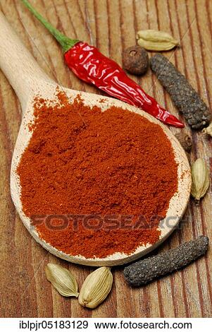 Stock Photo - Powder in a wooden spoon (Berbere), spice mixture of chili, pimento, cardamom, pepper, -spice mixture. Fotosearch