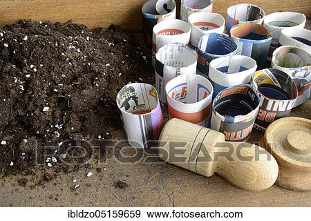 Production paper plant pot, potting soil View Large Photo Image Stock Photo - Production paper plant pot, potting soil. Fotosearch