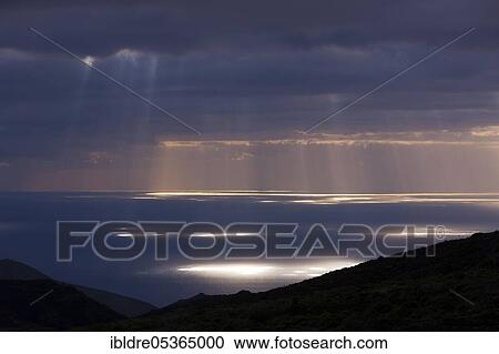 Stock Image - Rays of sunshine break through the cloud cover, Tenerife, Canary Islands, Spain, Europe. Fotosearch