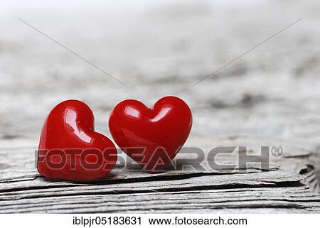 Stock Image - Red hearts on old wood. Fotosearch