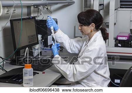 Stock Photo - Research assistant at the pipetting robot of the Faculty of Biology at the University of Duisburg-Essen during research work, Essen, North Rhine-Westphalia, Germany, Europe. Fotosearch