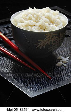 Picture - Rice bowl with chopsticks, rice grain, rice grains. Fotosearch