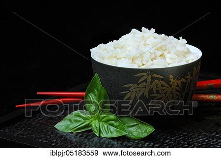 Rice bowl with chopsticks, rice grain, rice grains View Large Photo Image Stock Photo - Rice bowl with chopsticks, rice grain, rice grains. Fotosearch