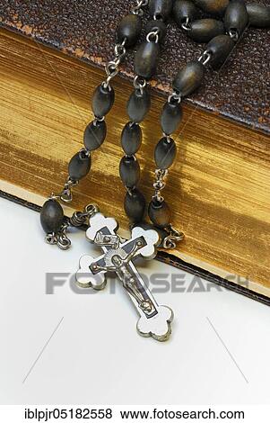 Stock Photo - Rosary, crucifix, on bible, cross, Jesus cross, rosary chain. Fotosearch