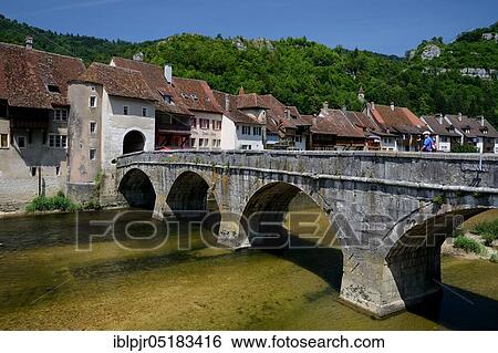 Stock Photograph - Saint-Ursanne, district of Porrentruy, Johann-Tor, St-, St-, St-, bridge and Porte St. Jean with river Doubs, Hirstorische Kleinstadt, canton Jura, Switzerland, Europe. Fotosearch
