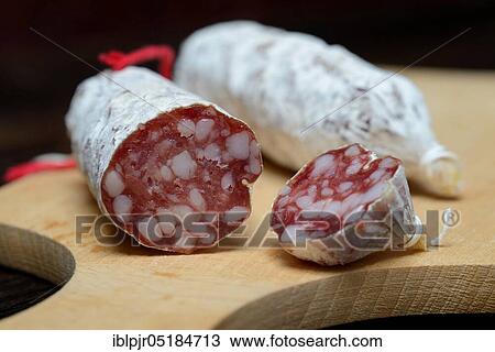 Stock Image - Salami, salametti on wooden board, Dauerwurst, Dauerwürste. Fotosearch