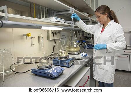 Stock Photograph - Scientist of biology at stirring devices in the genetic engineering section of the laboratories of the University of Duisburg-Essen. Fotosearch