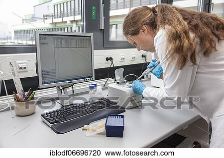 Stock Image - Scientist of biology pipetting in the genetic engineering area of the laboratories of the University of Duisburg-Essen. Fotosearch