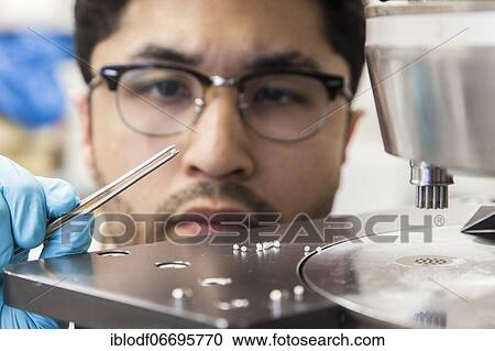 Scientists during their research work on a tablet press at the Institute for Pharmaceutical Technology and Biopharmacy at Heinrich-Heine-University Düsseldorf, North Rhine-Westphalia, Germany, Europe View Large Photo Image Stock Image - Scientists during their research work on a tablet press at the Institute for Pharmaceutical Technology and Biopharmacy at Heinrich-Heine-University Düsseldorf, North Rhine-Westphalia, Germany, Europe. Fotosearch