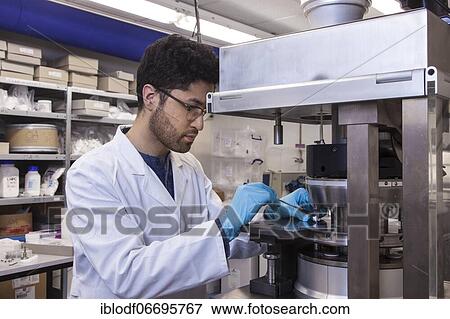 Scientists during their research work on a tablet press at the Institute for Pharmaceutical Technology and Biopharmacy at Heinrich-Heine-University Düsseldorf, North Rhine-Westphalia, Germany, Europe View Large Photo Image Stock Photo - Scientists during their research work on a tablet press at the Institute for Pharmaceutical Technology and Biopharmacy at Heinrich-Heine-University Düsseldorf, North Rhine-Westphalia, Germany, Europe. Fotosearch