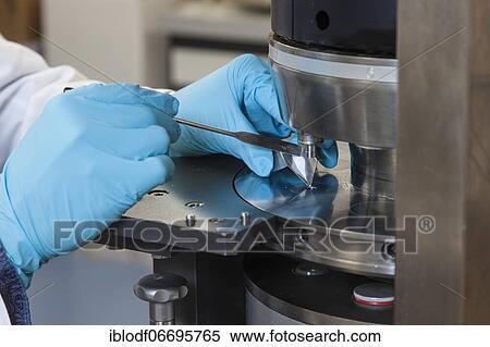 Stock Photography - Scientists during their research work on a tablet press at the Institute for Pharmaceutical Technology and Biopharmacy at Heinrich-Heine-University Düsseldorf, North Rhine-Westphalia, Germany, Europe. Fotosearch