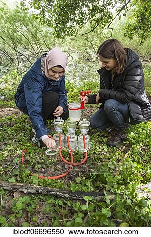 Stock Image - Scientists of the working group of Prof. Dr. Jens Boenigk of the University of Duisburg-Essen filtering water samples near Grietherbusch on the Lower Rhine, North Rhine-Westphalia, Germany, Europe. Fotosearch