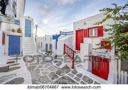 Small alley with white Cycladic houses with colorful shutters and doors, Chora, Mykonos Town, Mykonos, Cyclades, Aegean Sea, Greece, Europe View Large Photo Image Stock Photo - Small alley with white Cycladic houses with colorful shutters and doors, Chora, Mykonos Town, Mykonos, Cyclades, Aegean Sea, Greece, Europe. Fotosearch