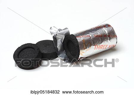 Stock Image - Smoking coal with incense, accessories for smoking. Fotosearch