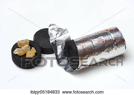 Stock Image - Smoking coal with incense, accessories for smoking, resin. Fotosearch