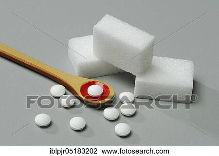 Stock Image - Sugar cubes and sweetener tablets, saccharin, cyclamate, sweetener, artificial, sugar cubes, sugar cubes, sweetener tablets. Fotosearch