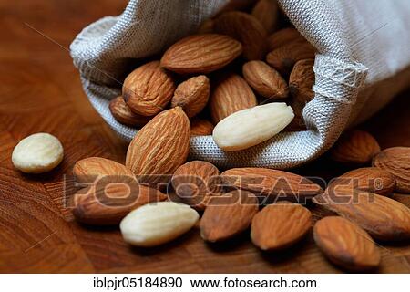 Stock Image - Sweet almonds in linen bags ( Prunus dulcis). Fotosearch
