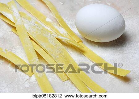 Stock Image - Tagliatelle and hen's egg, ribbon noodles, pasta, hen's egg, hen's eggs, flour. Fotosearch