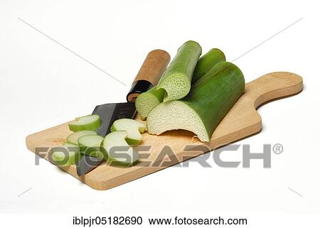 Stock Image - Taroleaf stalks and knives, chopping board, carrot root, coco-yam (Colocasia esculenta) Kalo, Taioba, Eddo, Eddoe, Eddro, Dasheen. Fotosearch