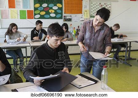 Teaching a refugee class or AVI, Ausbildungsvorbereitung International at the Elly-Heuss-Knapp-Schule, a vocational college of the city of Düsseldorf, North Rhine-Westphalia, Germany, Europe View Large Photo Image Stock Image - Teaching a refugee class or AVI, Ausbildungsvorbereitung International at the Elly-Heuss-Knapp-Schule, a vocational college of the city of Düsseldorf, North Rhine-Westphalia, Germany, Europe. Fotosearch