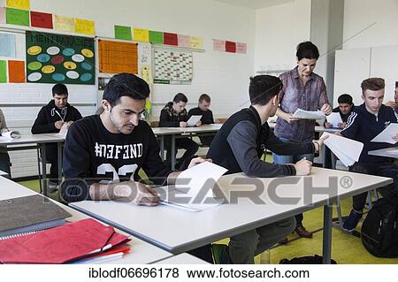 Stock Photo - Teaching a refugee class or AVI, Ausbildungsvorbereitung International at the Elly-Heuss-Knapp-Schule, a vocational college of the city of Düsseldorf, North Rhine-Westphalia, Germany, Europe. Fotosearch