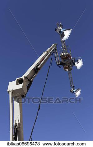 Three spotlights in front of a blue sky, mounted on a working stage, Filmlicht, Düsseldorf, North Rhine-Westphalia, Germany, Europe View Large Photo Image Stock Photo - Three spotlights in front of a blue sky, mounted on a working stage, Filmlicht, Düsseldorf, North Rhine-Westphalia, Germany, Europe. Fotosearch