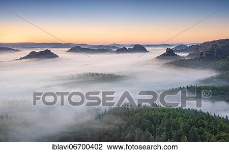 Stock Image - View from Kleiner Winterberg at dawn, morning fog, Elbe Sandstone Mountains, National Park Saxon Switzerland, Saxony, Germany, Europe. Fotosearch