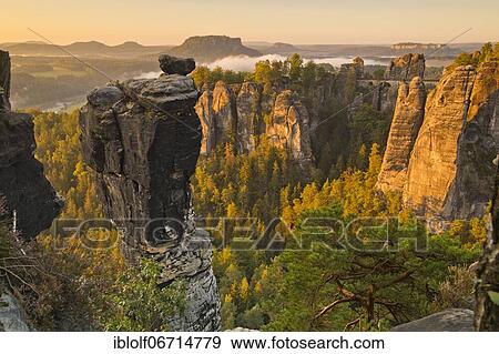 View to the Bastei, Bastei bridge, with Wehlnadel and Wehlgrund, in the back Lilienstein, at sunrise, National Park Saxon Switzerland, Elbe Sandstone Mountains, Saxony, Germany, Europe View Large Photo Image Stock Photo - View to the Bastei, Bastei bridge, with Wehlnadel and Wehlgrund, in the back Lilienstein, at sunrise, National Park Saxon Switzerland, Elbe Sandstone Mountains, Saxony, Germany, Europe. Fotosearch