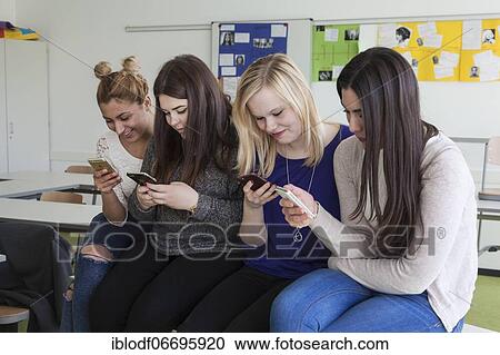 Vocational school students with their smartphones during break at the Elly-Heuss-Knapp-Schule, a vocational college of the city of Düsseldorf, North Rhine-Westphalia, Germany, Europe View Large Photo Image Stock Image - Vocational school students with their smartphones during break at the Elly-Heuss-Knapp-Schule, a vocational college of the city of Düsseldorf, North Rhine-Westphalia, Germany, Europe. Fotosearch