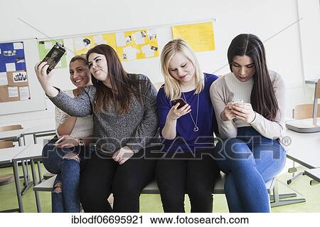 Vocational school students with their smartphones during break at the Elly-Heuss-Knapp-Schule, a vocational college of the city of Düsseldorf, North Rhine-Westphalia, Germany, Europe View Large Photo Image Stock Image - Vocational school students with their smartphones during break at the Elly-Heuss-Knapp-Schule, a vocational college of the city of Düsseldorf, North Rhine-Westphalia, Germany, Europe. Fotosearch